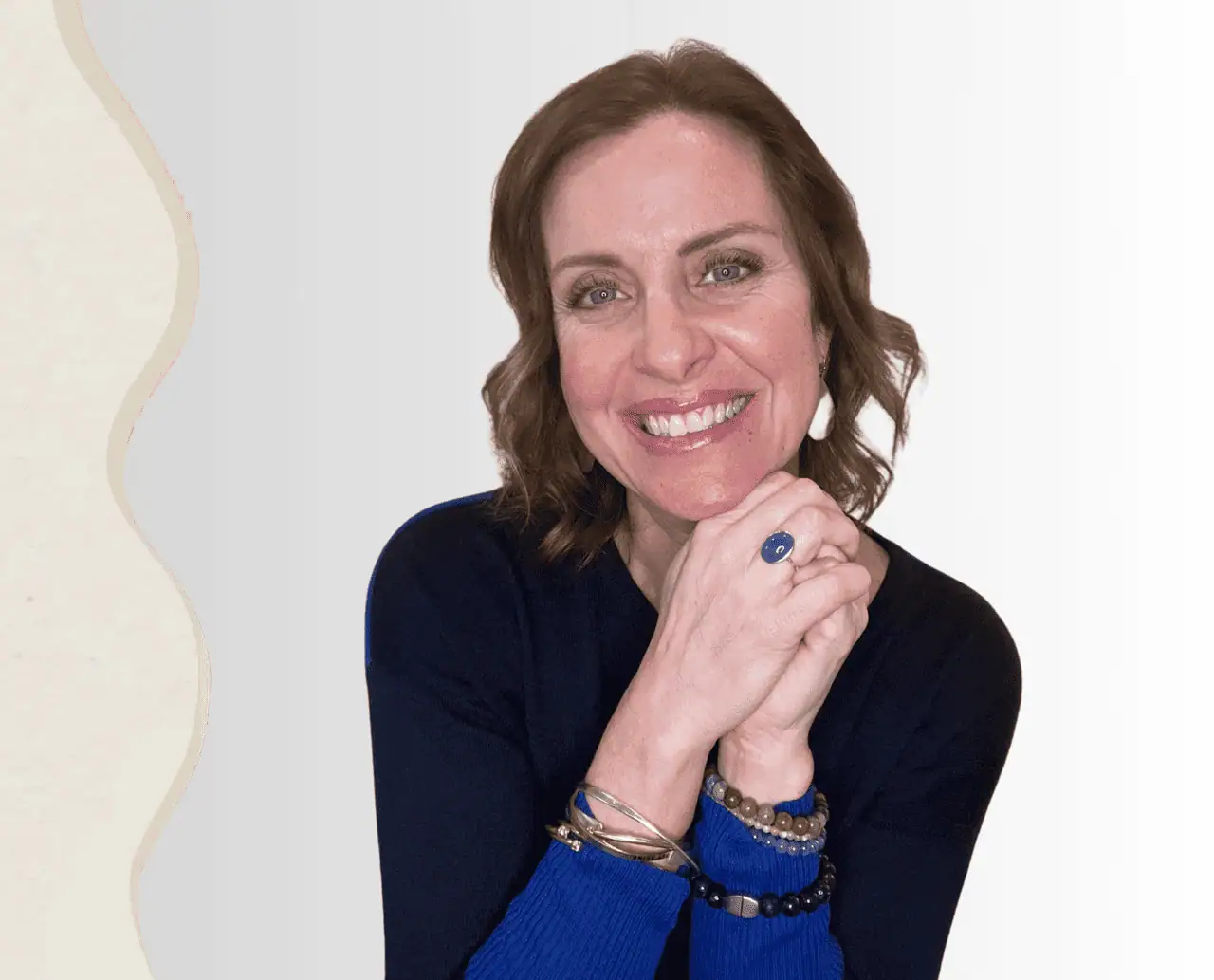 Mom, Dad, boys, and a girlfriend are all smiling arm in arm at the beach.