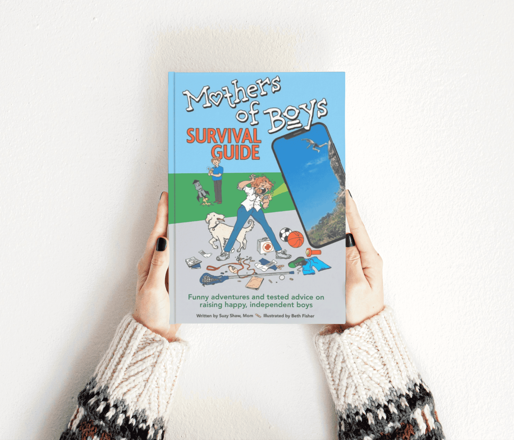 Mothers of Boys Survival Guide book held in woman's hands.