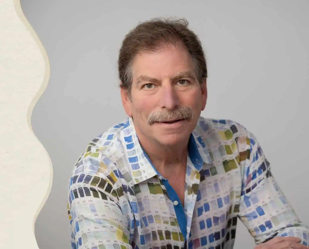 Mom, Dad, boys, and a girlfriend are all smiling arm in arm at the beach.